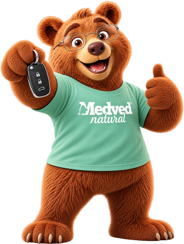 Maskot Medveď drží kľúče a ukazuje palec hore